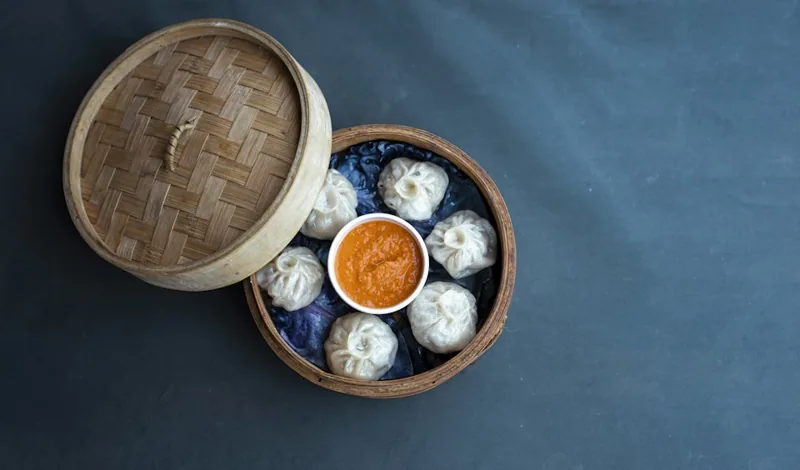 Steamed momo with tomato achar